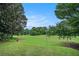 Picturesque view of a lush golf course featuring manicured green grass, trees and open blue skies at 170 Elysian Nw Way, Atlanta, GA 30327
