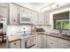 Well-lit kitchen with granite countertops, white cabinetry, and modern appliances at 170 Elysian Nw Way, Atlanta, GA 30327