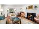 Comfortable living room with fireplace and wood floors, flowing into the dining room at 170 Elysian Nw Way, Atlanta, GA 30327