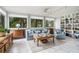 Bright sunroom with multiple windows, bookshelves and light-colored furniture at 170 Elysian Nw Way, Atlanta, GA 30327