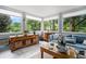 Light-filled sunroom with large windows and view of wooded property at 170 Elysian Nw Way, Atlanta, GA 30327
