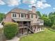 Large backyard featuring a deck, patio, and lush lawn for outdoor enjoyment at 1888 Sever Creek Cir, Lawrenceville, GA 30043