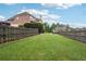 Large backyard with green grass and wood fence offering space and privacy at 1888 Sever Creek Cir, Lawrenceville, GA 30043