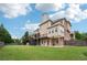 Expansive backyard featuring a deck, patio, and lush lawn for outdoor enjoyment at 1888 Sever Creek Cir, Lawrenceville, GA 30043