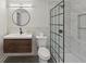 Modern bathroom with sleek black hardware, glass shower, and natural wood vanity at 1888 Sever Creek Cir, Lawrenceville, GA 30043
