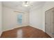Light-filled bedroom featuring hardwood floors and a ceiling fan at 1888 Sever Creek Cir, Lawrenceville, GA 30043