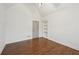 Bedroom with hardwood floors, built-in shelves, and a door at 1888 Sever Creek Cir, Lawrenceville, GA 30043