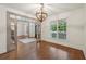 Formal dining room with hardwood floors, elegant chandelier, and glass paneled doorway at 1888 Sever Creek Cir, Lawrenceville, GA 30043