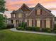 Elegant two-story brick home with manicured landscaping, charming porch, and classic architectural details creates a welcoming entrance at 1888 Sever Creek Cir, Lawrenceville, GA 30043