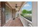Inviting covered front porch with brick flooring, white railings, and a cozy ceiling fan at 1888 Sever Creek Cir, Lawrenceville, GA 30043