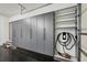 Spacious garage with ample gray cabinets and shelves along with an electric car charger at 1888 Sever Creek Cir, Lawrenceville, GA 30043