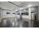 Spacious garage with epoxy floor, storage cabinets, slat wall, lighting, and windows at 1888 Sever Creek Cir, Lawrenceville, GA 30043