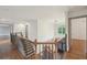 Beautiful hallway with hardwood floors, iron banister, and modern light fixture at 1888 Sever Creek Cir, Lawrenceville, GA 30043