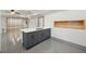 Modern kitchen island with gray cabinetry, white countertop, and open access to living space at 1888 Sever Creek Cir, Lawrenceville, GA 30043