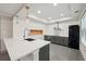 Kitchen features sleek countertops, gray cabinets, stainless appliances, and modern pendants at 1888 Sever Creek Cir, Lawrenceville, GA 30043