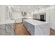 Open concept kitchen with white and gray cabinets, quartz countertops and stainless steel appliances at 1888 Sever Creek Cir, Lawrenceville, GA 30043