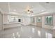 Open-concept living area with view into the adjacent modern kitchen and bright sunlight at 1888 Sever Creek Cir, Lawrenceville, GA 30043