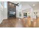 Bright living room with tall ceilings, fireplace accent wall, and an open layout to the kitchen at 1888 Sever Creek Cir, Lawrenceville, GA 30043