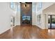 Spacious living room with a fireplace feature wall, soaring ceilings, and large windows at 1888 Sever Creek Cir, Lawrenceville, GA 30043