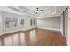 Spacious main bedroom with tray ceilings, large windows, hardwood floors and barn door to bathroom at 1888 Sever Creek Cir, Lawrenceville, GA 30043