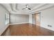 Main bedroom featuring wood floors, a tray ceiling and barn door to the ensuite bath at 1888 Sever Creek Cir, Lawrenceville, GA 30043