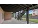 Covered patio with gray columns and stairs leading to the upper deck at 1888 Sever Creek Cir, Lawrenceville, GA 30043