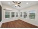 Sunroom featuring hardwood floors, a ceiling fan, and multiple windows for natural light at 1888 Sever Creek Cir, Lawrenceville, GA 30043