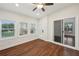 Bright sunroom featuring hardwood floors, large windows offering pleasant views and a ceiling fan at 1888 Sever Creek Cir, Lawrenceville, GA 30043