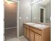 Bright bathroom with double sinks, wooden vanity, large mirror and walk-in closet view at 1976 Glen Echo Dr, Decatur, GA 30032