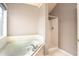 Clean bathroom featuring a soaking tub, a separate shower stall, and tiled floors at 1976 Glen Echo Dr, Decatur, GA 30032