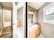 Dual image showcasing the bathroom vanity, sink, and a view into the closet space at 1976 Glen Echo Dr, Decatur, GA 30032