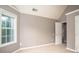Bedroom with neutral walls, a window and an open doorway at 1976 Glen Echo Dr, Decatur, GA 30032