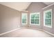Bedroom featuring neutral walls, carpet, trim and three windows offering ample natural light at 1976 Glen Echo Dr, Decatur, GA 30032