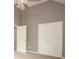 Bedroom with neutral walls, carpet, a window, and double closet doors at 1976 Glen Echo Dr, Decatur, GA 30032