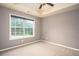 Bedroom featuring neutral walls, carpet, tray ceiling, and a large window with blinds at 1976 Glen Echo Dr, Decatur, GA 30032