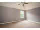 Bedroom with neutral walls, carpet, and a window, with a ceiling fan for added comfort at 1976 Glen Echo Dr, Decatur, GA 30032