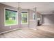 Light-filled dining area with hardwood floors, chandelier, and view of living room at 1976 Glen Echo Dr, Decatur, GA 30032