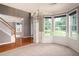 Open-concept dining area with hardwood floors, a chandelier, and lots of natural light at 1976 Glen Echo Dr, Decatur, GA 30032