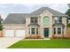 Beautiful two-story brick house with a manicured lawn, showcasing its curb appeal and double garage at 1976 Glen Echo Dr, Decatur, GA 30032