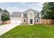 Charming two-story home with a well-manicured lawn, brick facade, and a two-car garage at 1976 Glen Echo Dr, Decatur, GA 30032