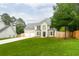 Attractive two-story home featuring a brick facade, lush lawn, and a driveway leading to the garage at 1976 Glen Echo Dr, Decatur, GA 30032
