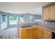 Bright kitchen featuring wooden cabinets, stainless steel sink, and large windows overlooking the backyard at 1976 Glen Echo Dr, Decatur, GA 30032