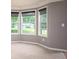 Bright living room with a bay window, neutral carpet, and gray walls at 1976 Glen Echo Dr, Decatur, GA 30032