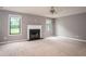 Spacious living room with fireplace, neutral walls, ceiling fan, and large windows at 1976 Glen Echo Dr, Decatur, GA 30032