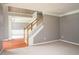 Open living room with staircase, hardwood entry, and view into the adjacent dining area at 1976 Glen Echo Dr, Decatur, GA 30032