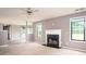 Bright living room with fireplace, ceiling fan, and open access to other rooms at 1976 Glen Echo Dr, Decatur, GA 30032