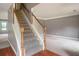 Carpeted staircase with a wooden handrail provides access to the upper level, adjacent to a living area at 1976 Glen Echo Dr, Decatur, GA 30032