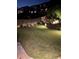 Backyard at night with landscape lighting accenting the greenery and stone wall at 4207 N Carver Dr, Atlanta, GA 30360
