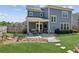 Beautiful backyard with stone patio, outdoor seating, lush grass, and professionally designed landscaping at 4207 N Carver Dr, Atlanta, GA 30360