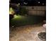 Landscaped backyard with a stone patio, grassy area and wood fence with lighting at 4207 N Carver Dr, Atlanta, GA 30360